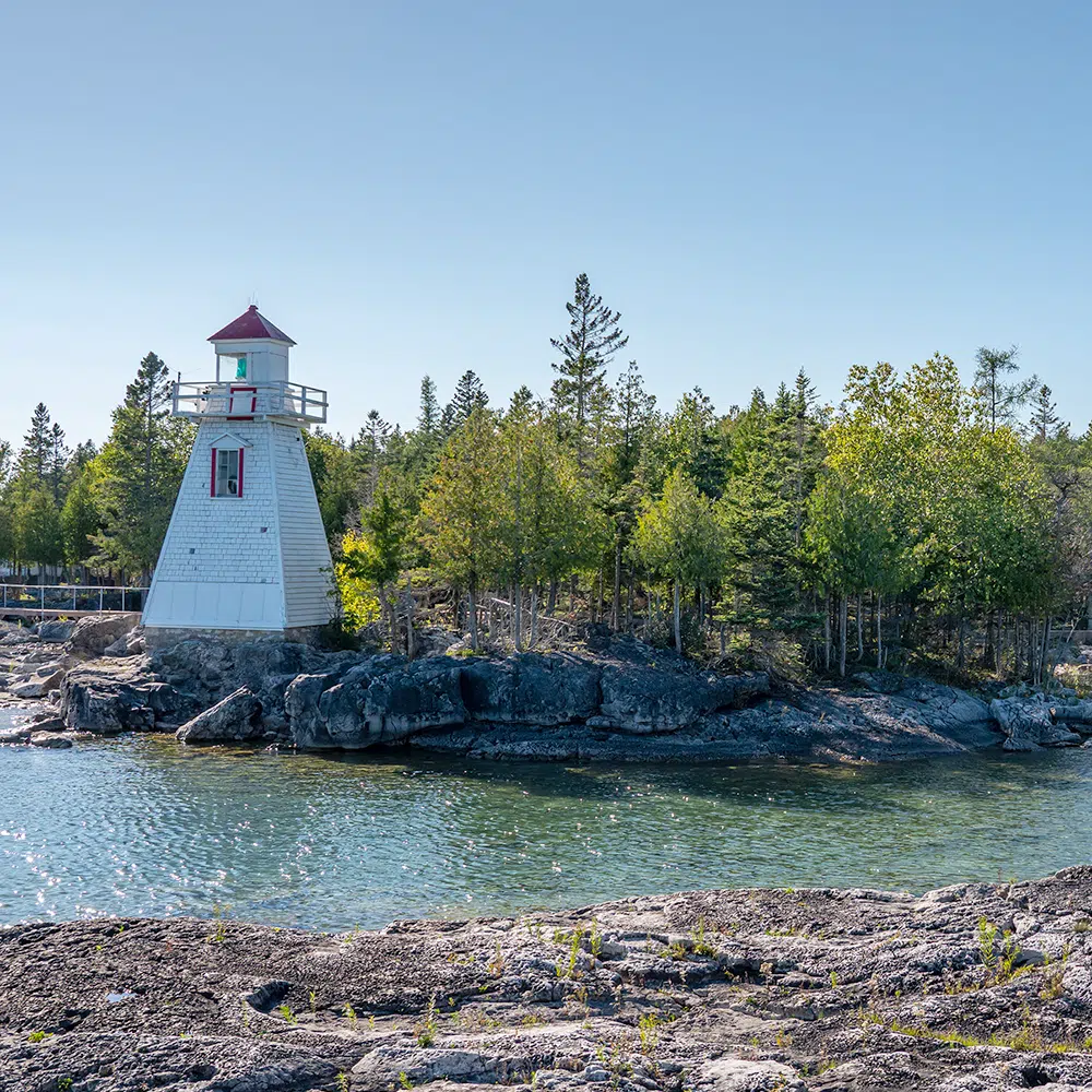 Calm waters surround Manitoulin Island lighthouse