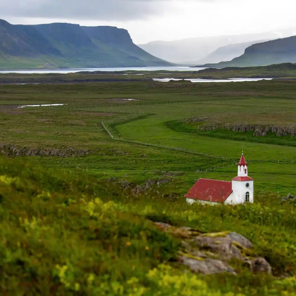 travelling-arctic A church standing in front of Helgafell mountain on Heimaey island, in Iceland