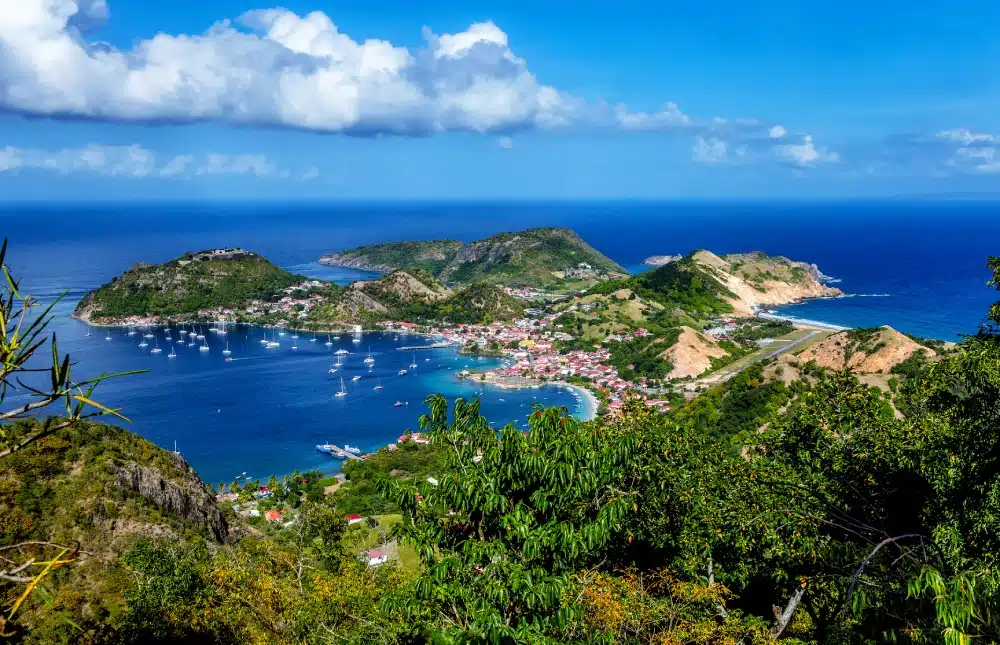 image-une Aerial view of Les Saintes Bay with sailing boats at anchor
