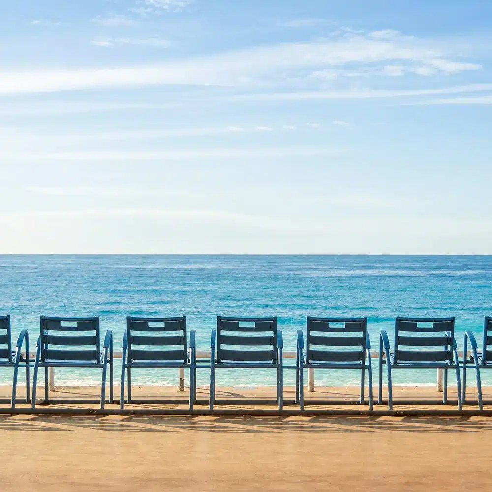 Low-Resolution-Promenade-of-Nice,-France Les célèbres chaises bleues de la promenade des Anglais à Nice, Côte d’Azur, French Riviera, France